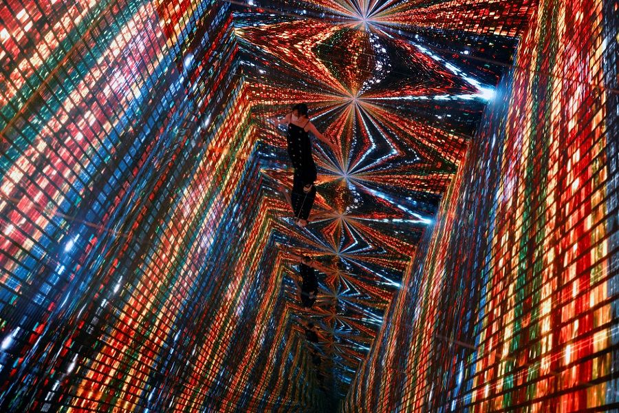 A visitor is pictured in front of an immersive art installation titled "Machine Hallucinations - Space: Metaverse" by media artist Refik Anadol, which will be converted into NFT and auctioned online at Sotheby's, at the Digital Art Fair, in Hong Kong, China, 30 September 2021. (Tyrone Siu/Reuters)