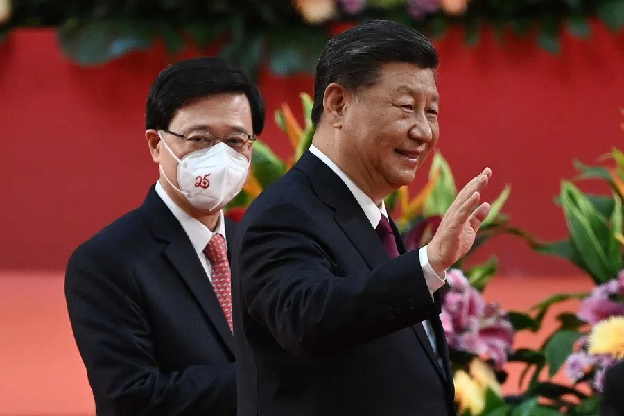 Hong Kong's new Chief Executive John Lee (left) walks with China's President Xi Jinping (right) following Xi's speech after a ceremony to inaugurate the city's new leader and government in Hong Kong on 1 July 2022, on the 25th anniversary of the city's handover from Britain to China. (Selim Chtayti/Pool/AFP)