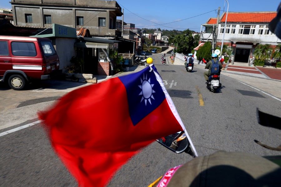 The flag of Taiwan flies on a scooter driving through a village on Kinmen, Taiwan, 18 October 2021. (Ann Wang/Reuters)