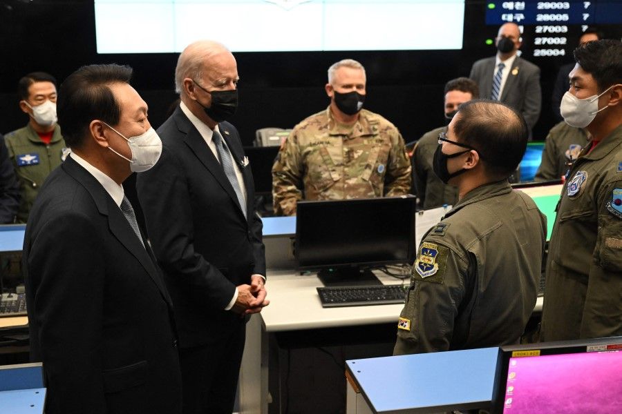 US President Joe Biden (second from left), accompanied by South Korea's President Yoon Suk-yeol (left), tours the Air Operations Center's Combat Operations Floor at Osan Air Base in Pyeongtaek on 22 May 2022. (Saul Loeb/AFP)