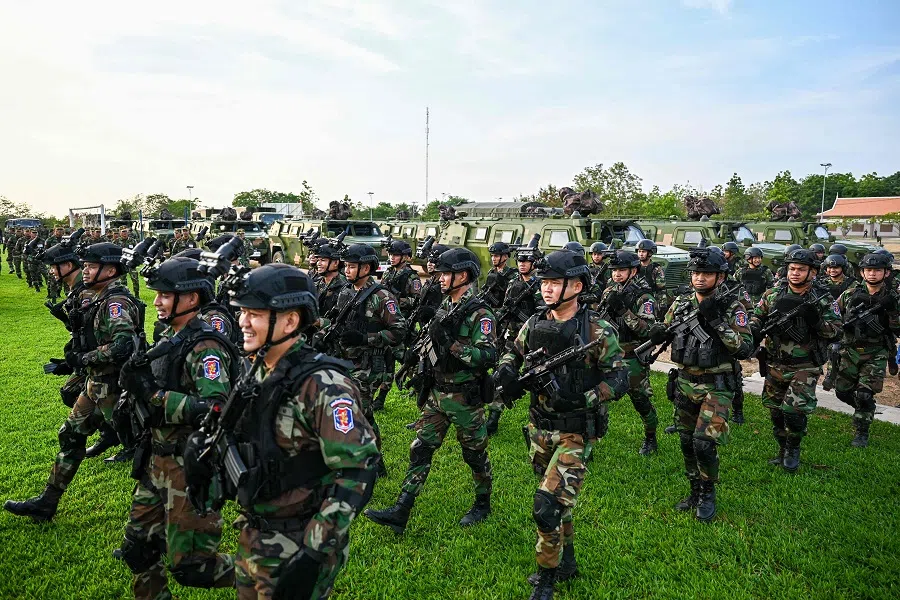 Cambodian soldiers walk in formation at a military police base in Kampong Chhnang province on 16 May 2024.  (Tang Chhin Sothy/AFP)