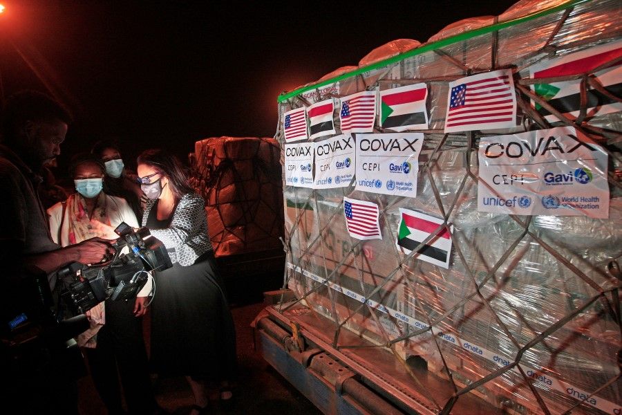 A shipment of vaccines provided for Sudan by the Covid-19 Vaccines Global Access (COVAX) is received by local officials at Khartoum International Airport late on 5 August 2021. (Ebrahim Hamid/AFP)