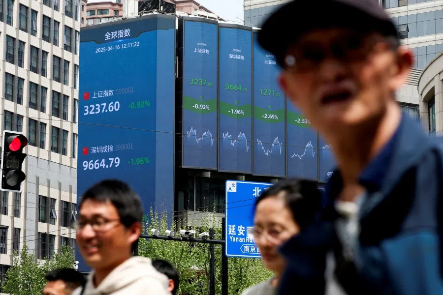 An electronic board shows Shanghai and Shenzhen stock indices in Shanghai, China, 16 April 2025. (Go Nakamura/Reuters)