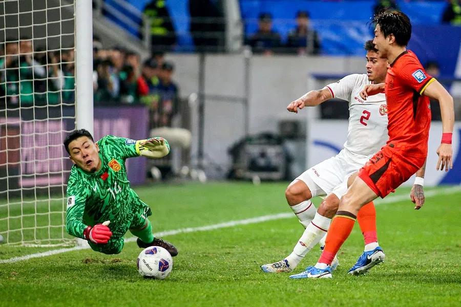 China’s goalkeeper Wang Dalei stops the ball during the 2026 FIFA World Cup Asian qualification football match between China and Indonesia at Qingdao, in eastern China’s Shandong province on 15 October 2024.