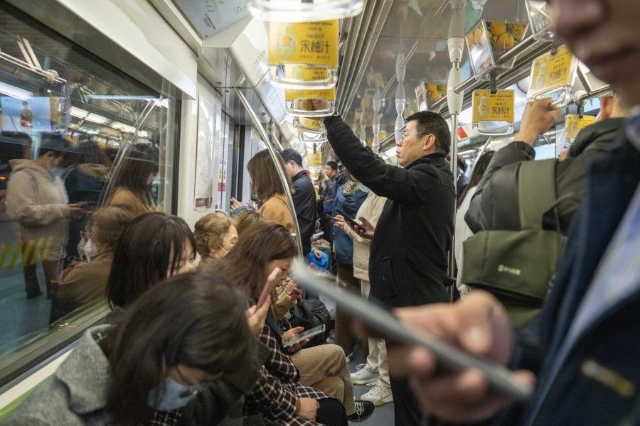 Commuters on a subway train in Shanghai, China, on 19 February 2024. (Raul Ariano/Bloomberg)