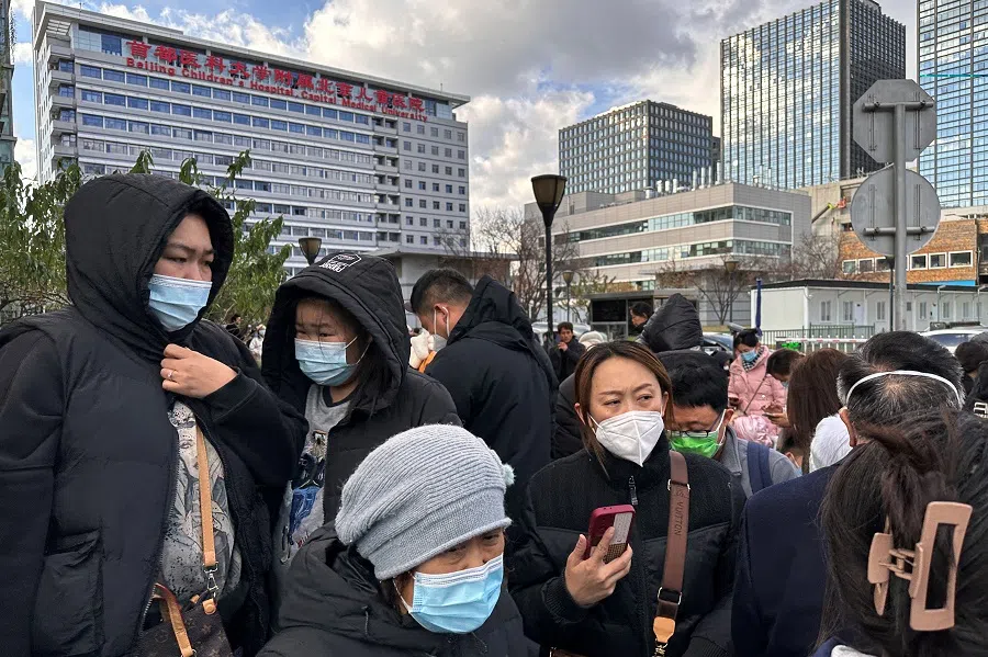 People outside a children's hospital in Beijing, China, on 27 November 2023. (Tingshu Wang/Reuters)
