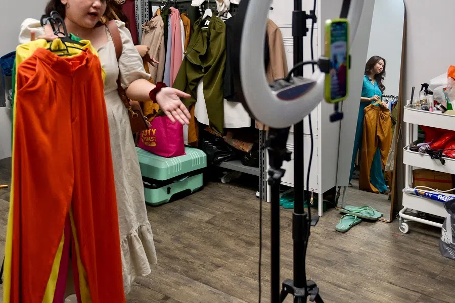 This picture taken on 4 April 2023 shows employees working for a TikTok channel offering merchandise for sale through a TikTok livestream at a room in Jakarta, Indonesia. (Bay Ismoyo/AFP)