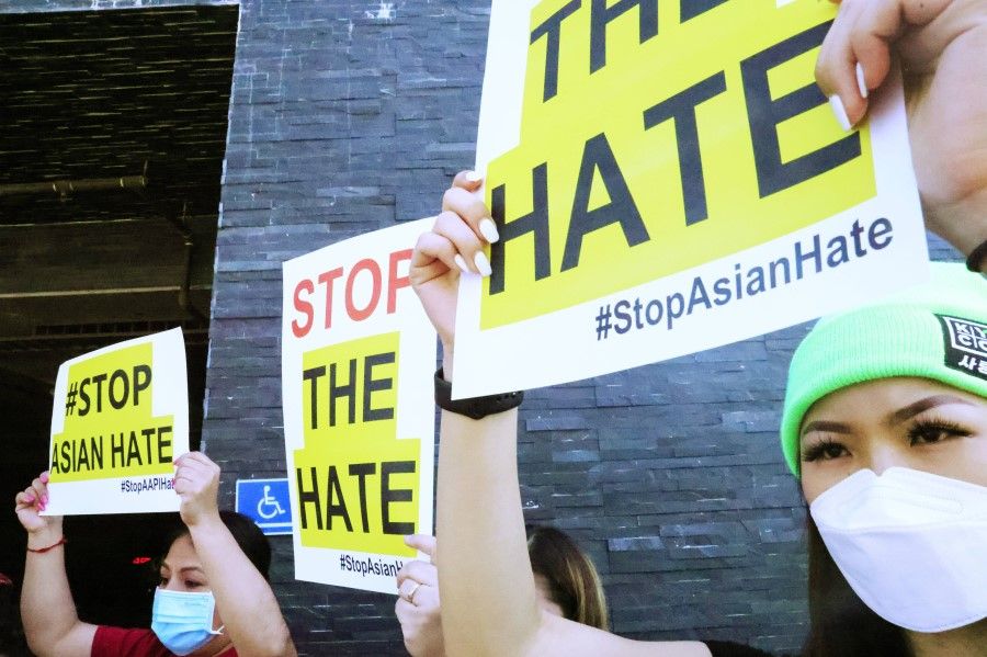 People protest hate crimes committed against Asian-American and Pacific Islander communities ahead of a car caravan in Koreatown on 19 March 2021 in Los Angeles, California. (Mario Tama/Getty Images/AFP)
