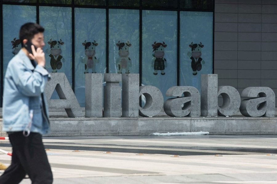 A man walks past Chinese e-commerce giant Alibaba's headquarters in Hangzhou in China's eastern Zhejiang province on 26 May 2022. (AFP)