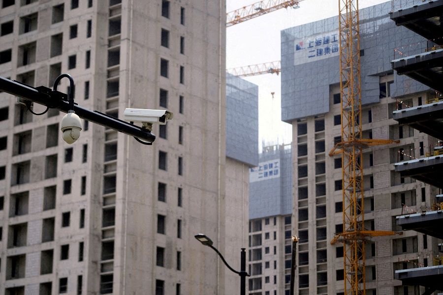 Surveillance cameras are seen near residential buildings under construction in Shanghai, China, 20 July 2022. (Aly Song/File Photo/Reuters)