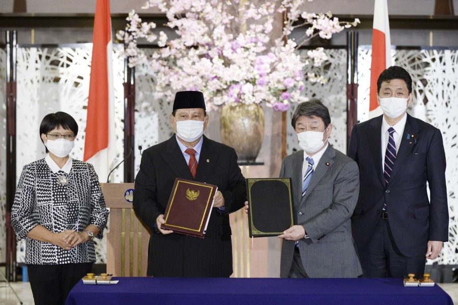 Japan's Foreign Minister Toshimitsu Motegi (centre right), Japan's Defence Minister Nobuo Kishi (right), Indonesia's Foreign Minister Retno Marsudi (left) and Indonesia's Defence Minister Prabowo Subianto (centre left) attend a signing ceremony at their "2+2" meeting at the Iikura Guest House of the Japanese foreign ministry in Tokyo on 30 March 2021. (David Mareuil/AFP)