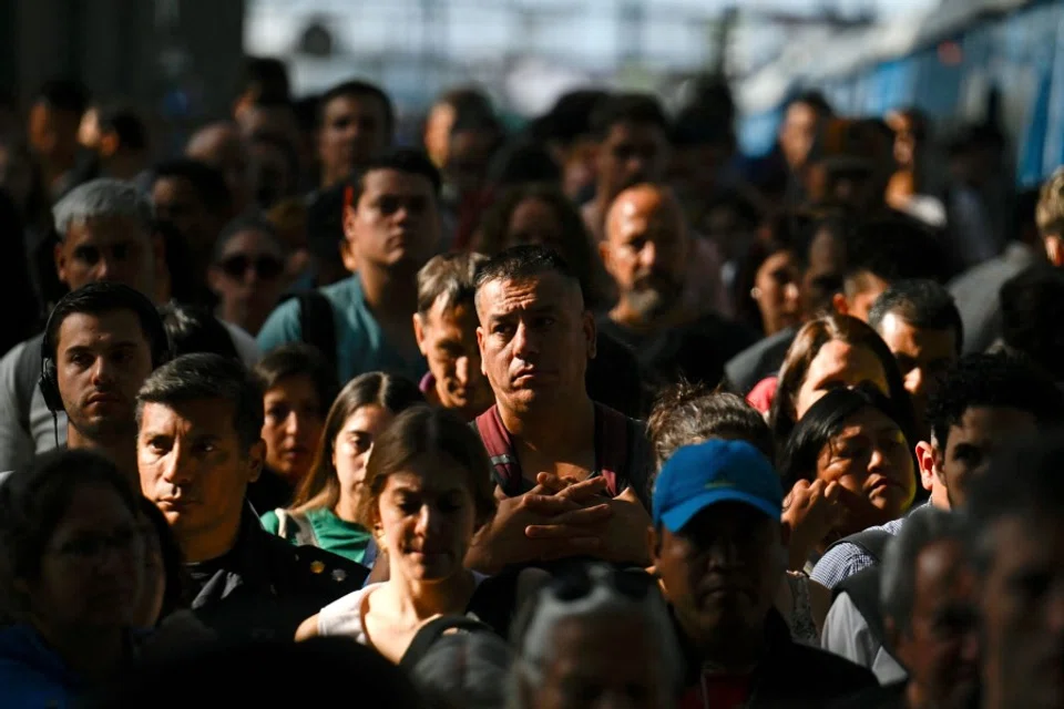 People walk inside the Constitución train station in Buenos Aires, on 9 January 2024. (Luis Robayo/AFP)