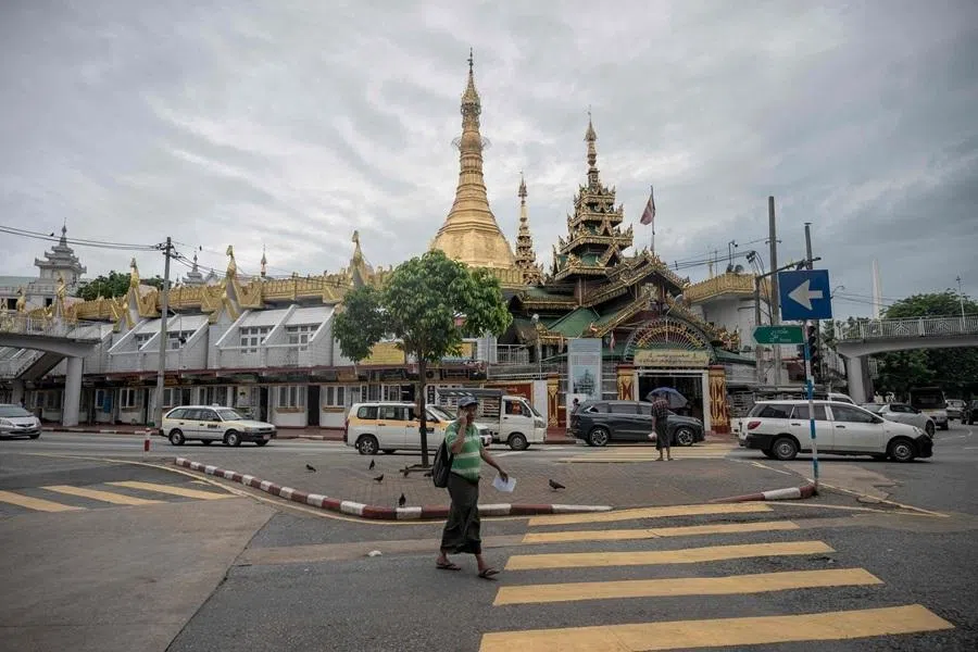 A man walks past Sule Pagoda in Yangon on 16 June 2026.