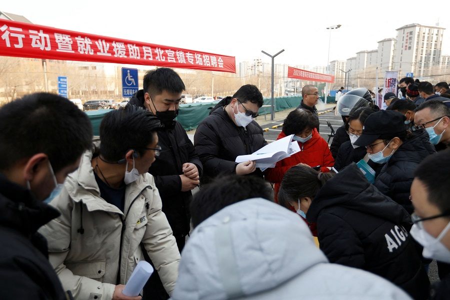 Job seekers attend a job fair in Beijing, China, 16 February 2023. (Florence Lo/Reuters)