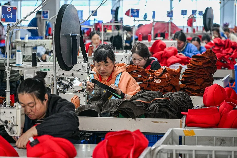 Employees work on a production line of caps that will be exported to the US at a factory in Suqian, in eastern China’s Jiangsu province on 7 April 2025. (AFP)