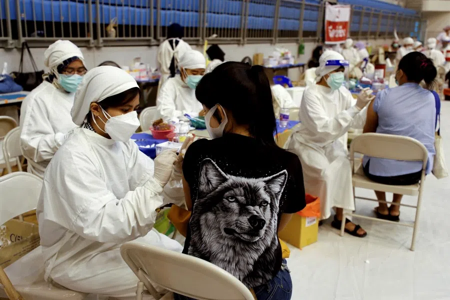 A woman receives the Sinovac Covid-19 vaccine as the Thai resort island of Phuket rushes to vaccinate its population amid the Covid-19 outbreak ahead of a 1 July end of strict quarantine for overseas visitors to bring back tourism revenue, in Phuket, Thailand, 28 June 2021. (Jorge Silva/Reuters)