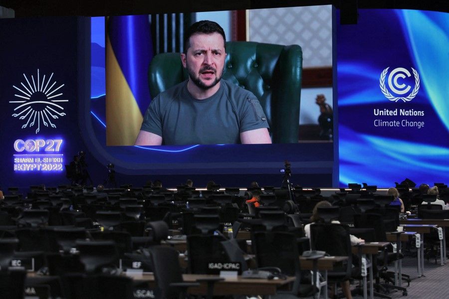 Ukrainian President Volodymyr Zelensky appears on a screen as he delivers a speech at the COP27 climate conference at the Sharm el-Sheikh International Convention Centre, in Egypt's Red Sea resort city of the same name, on 8 November 2022. (Ahmad Gharabli/AFP)