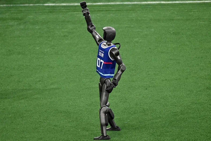 A humanoid robot celebrates after scoring a goal during a football match at the 2nd World Humanoid Robot Games in Beijing on 22 August 2026.