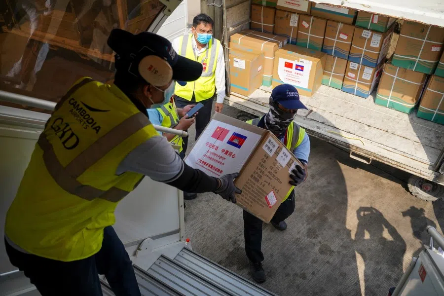 Medical supplies are carried from a plane as a flight arrives from China to Cambodia with supplies and doctors to contain the spread of the coronavirus outbreak, at Phnom Penh International Airport in Cambodia, 23 March 2020. (Cindy Liu/REUTERS)