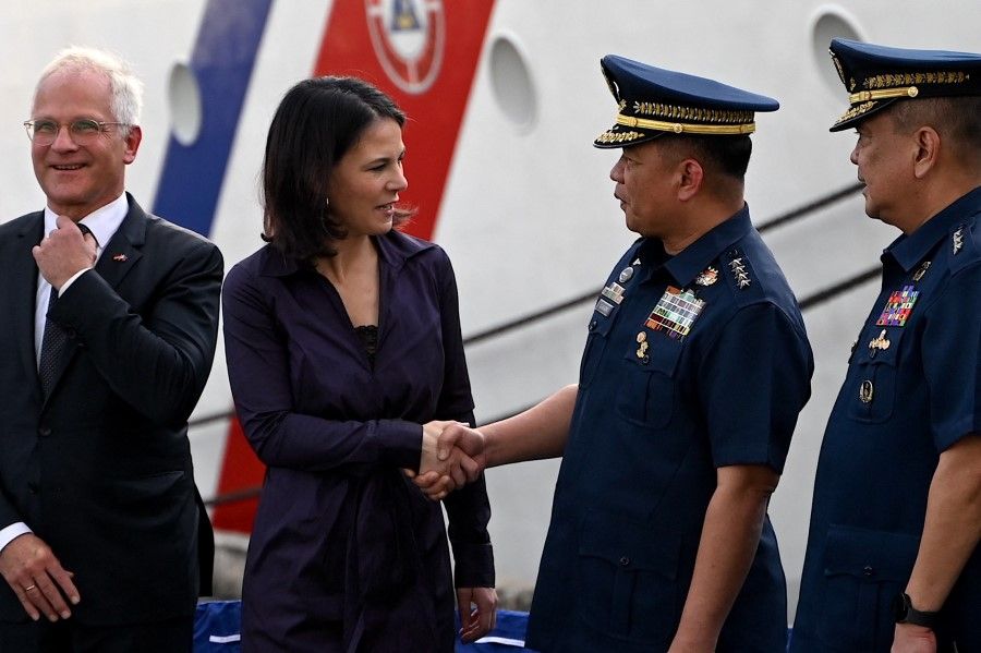 Philippine Coast Guard Admiral Ronnie Gil Gavan (second from right) shakes hands with German Foreign Minister Annalena Baerbock (second from left) during the courtesy visit at the Philippine Coast Guard headquarters in Manila on 11 January 2024. (Jam Sta Rosa/AFP)