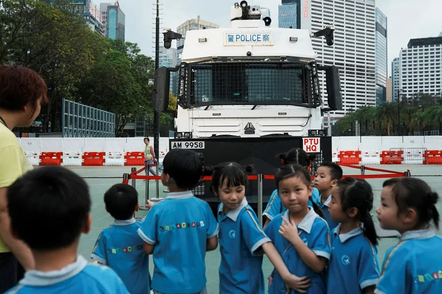 Children look at a water cannon vehicle at a carnival in Hong Kong, China, on 15 April 2024. (Lam Yik/Reuters)