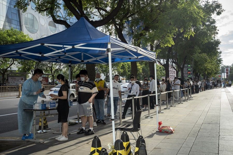 Residents queue at a Covid-19 testing station in Beijing, China, on 10 August 2022. (Bloomberg)