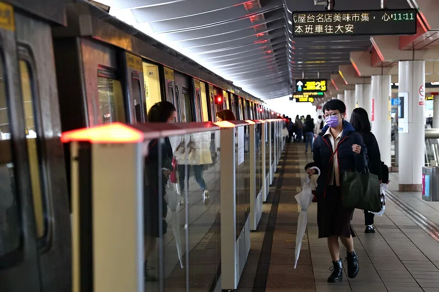 People wear protective masks to prevent the spread of the Covid-19 coronavirus while riding the metro in Taipei, Taiwan, 23 December 2020. (Ann Wang/Reuters)