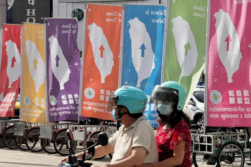 Local residents ride past pro-Taiwan independence flags in Taipei, Taiwan, on 6 August 2022. (Sam Yeh/AFP)