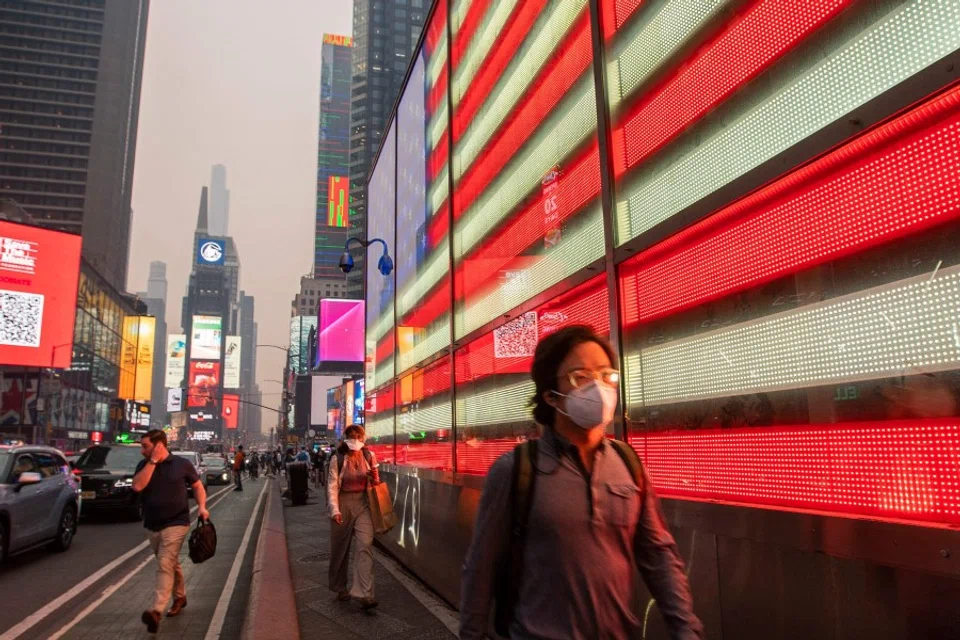 People make their way around Times Square amid smoke from Canada wildfires on 7 June 2023 in New York City. (Eduardo Munoz Alvarez/Getty Images/AFP)