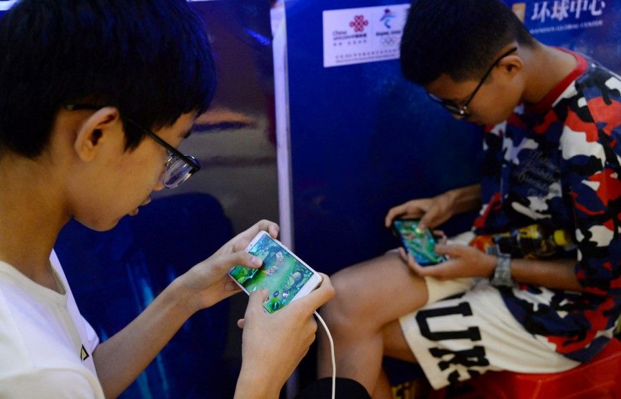 Young boys play the game "Honour of Kings" by Tencent, during an event inside a shopping mall in Handan, Hebei province, China 5 August 2018. (Stringer/Reuters)