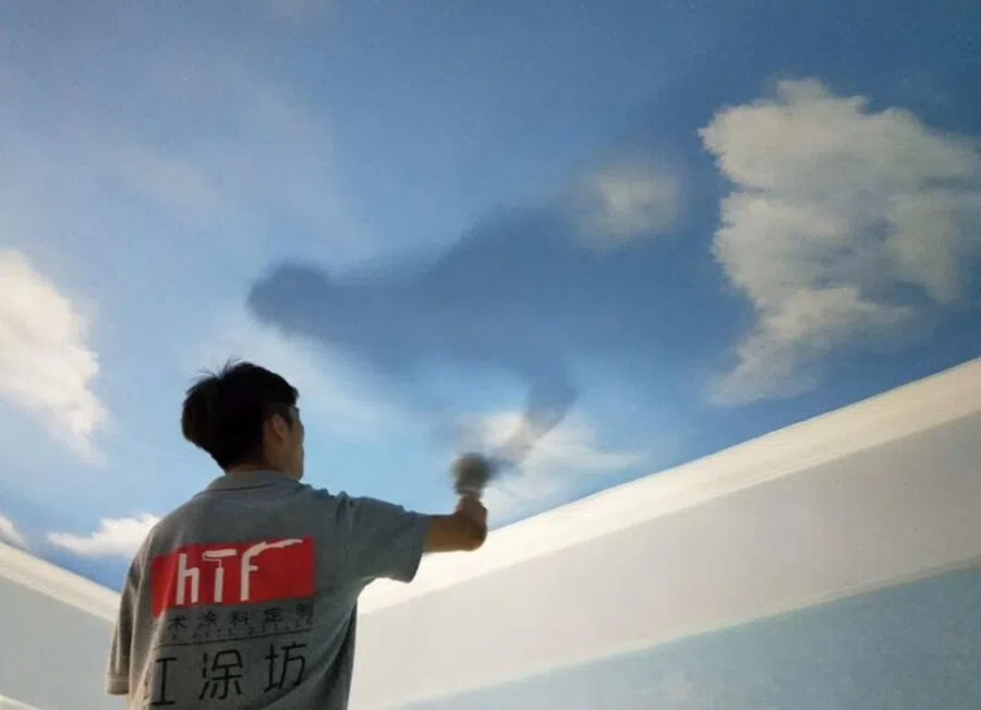 A worker in Guangzhou painting the ceiling of a villa. (Photo provided by interviewee)
