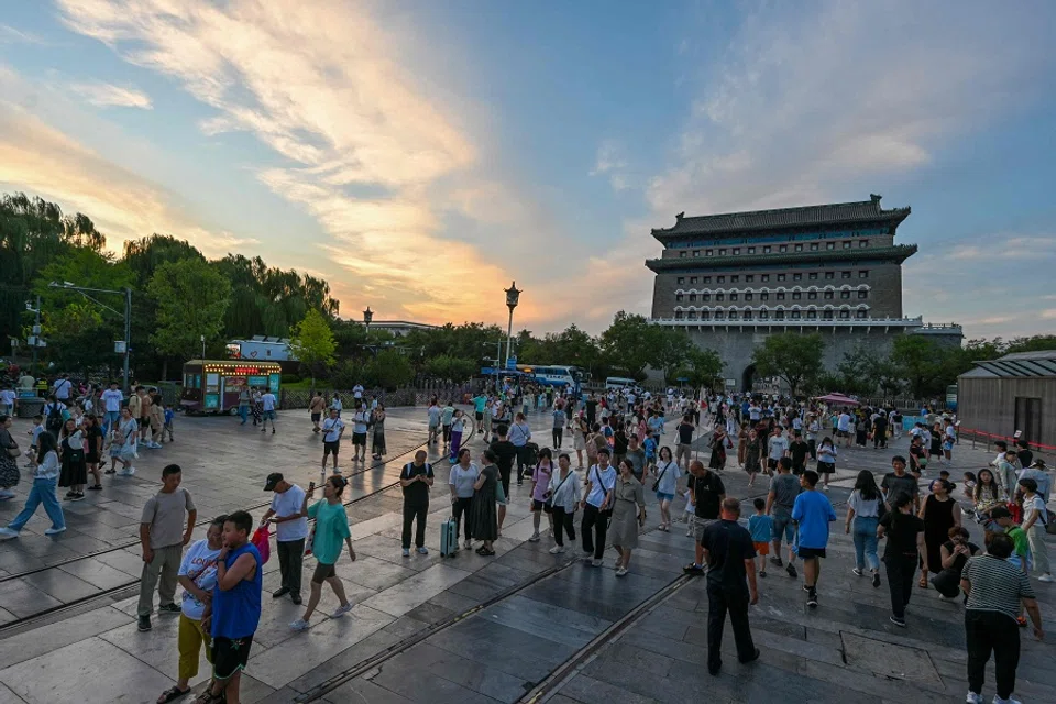 People visit Qianmen Street in Beijing on 8 August 2024. (Adek Berry/AFP)