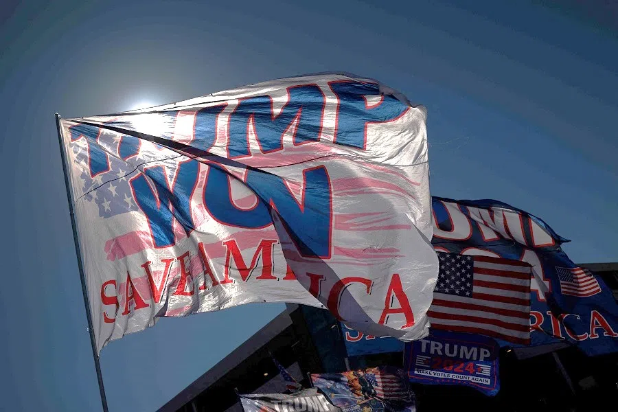 Supporters of Republican presidential candidate, former US President Donald Trump fly "Trump Won" signs in the parking lot before a rally on 14 February 2024 in North Charleston, South Carolina, US. (Win McNamee/Getty Images/AFP)