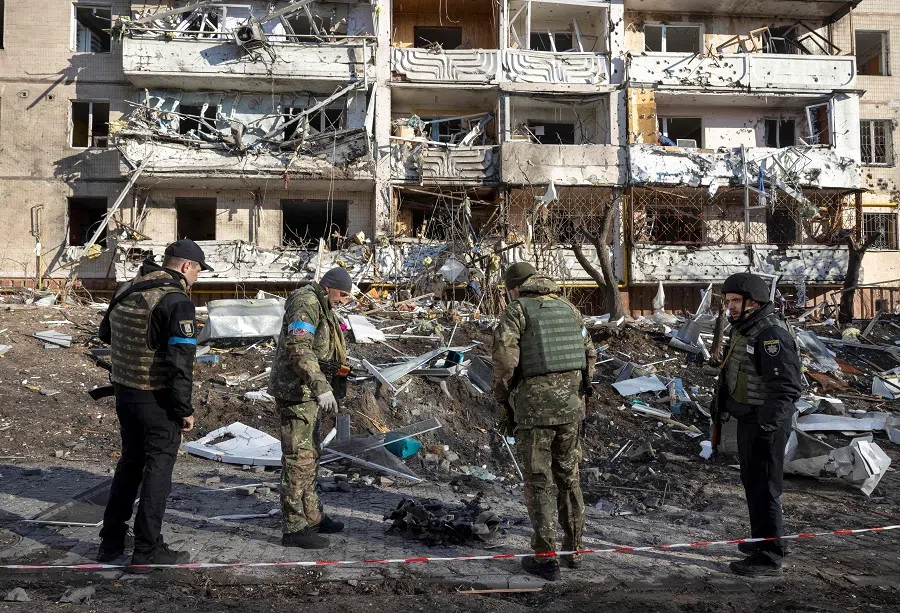 Ukraine soldiers inspect the rubble of a destroyed apartment building in Kyiv, Ukraine, on 15 March 2022. (Fadel Senna/AFP)