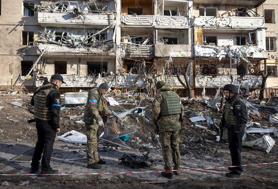 Ukraine soldiers inspect the rubble of a destroyed apartment building in Kyiv, Ukraine, on 15 March 2022. (Fadel Senna/AFP)