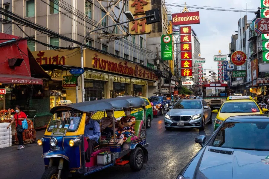 A tuk-tuk carries passengers through the Chinatown area of Bangkok on 4 January 2022. (Jack Taylor/AFP)