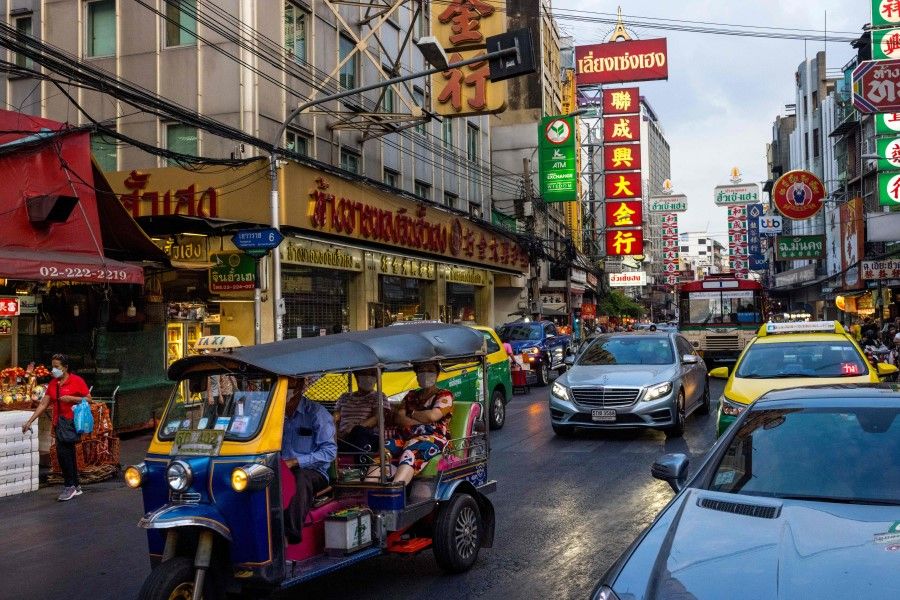 A tuk-tuk carries passengers through the Chinatown area of Bangkok on 4 January 2022. (Jack Taylor/AFP)
