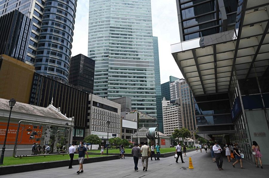 People walk along Raffles Place (Central Business District) in Singapore on 15 September 2020. (Roslan Rahman/AFP)