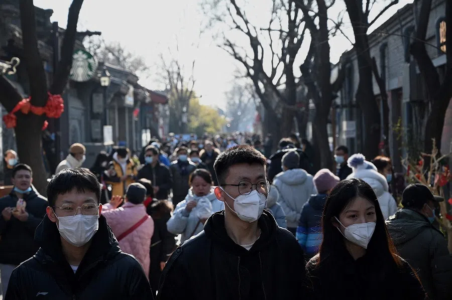 People walk through Nanluoguxiang alley in Beijing, China, on New Year's Day on 1 January 2022. (Noel Celis/AFP)