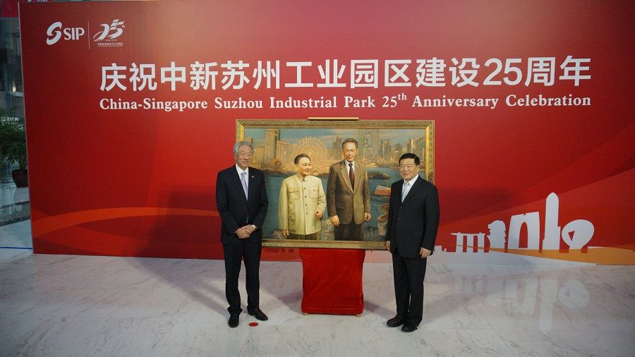 In this photo taken on 12 April 2019, former Singapore Deputy Prime Minister Teo Chee Hean (left) and China's Jiangsu Party Secretary Lou Qinjian jointly launched the China-Singapore Cooperation Gallery on the occasion of the 25th anniversary of the Suzhou Industrial Park (SIP) bilateral project. Behind them is a silk embroidery that replicates a 2014 painting by Wang Nen of Mr Lee Kuan Yew and Mr Deng Xiaoping with the backdrop of the SIP's evening skyline. (SPH)