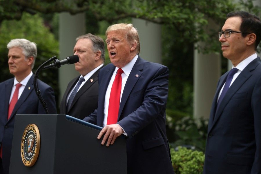 U.S. President Donald Trump makes an announcement about US trade relations with China and Hong Kong as national security adviser Robert O'Brien, Secretary of State Mike Pompeo and Treasury Secretary Steven Mnuchin listen in the Rose Garden of the White House in Washington, 29 May 2020. (Jonathan Ernst/REUTERS)