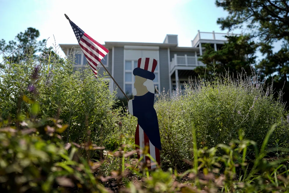 A patriotic figurine holding a US flag stands in Rehoboth Beach, Delaware, US, on 21 July 2024. (Ken Cedeno/Reuters)