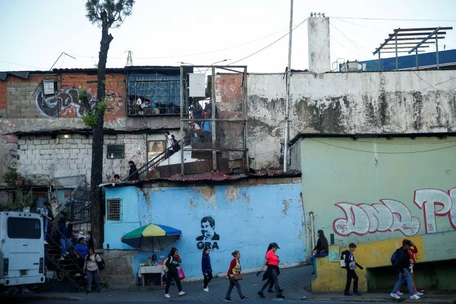People from a working-class neighbourhood walk to catch a public bus, in Caracas, Venezuela, on 20 January 2026.