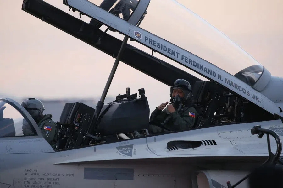This handout photo taken and received on 7 March 2023 from the Presidential Office shows Philippine President Ferdinand Marcos Jr (right, showing thumbs up) inside a FA-50PH fighter jet during a capability demonstration flight at Clark Airbase in Pampanga. (Handout/Presidential Office/AFP)