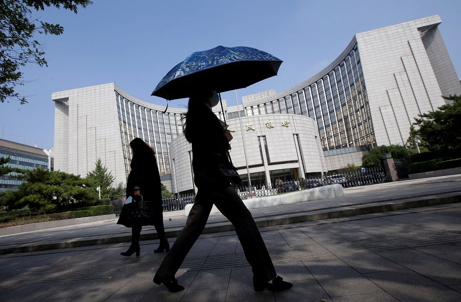 People walk past the headquarters of the People's Bank of China (PBOC), the central bank, in Beijing, China, on 28 September 2018. (Jason Lee/Reuters)