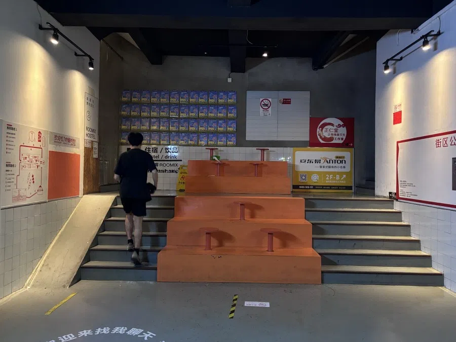 A resident goes up the steps at a youth hostel.