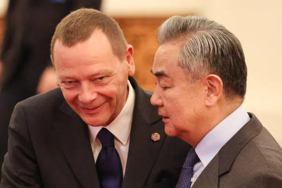 China’s Foreign Minister Wang Yi (R) speak with French diplomatic adviser Emmanuel Bonne during a welcome ceremony at the Great Hall of the People in Beijing on 4 December 2025. (Ludovic Marin/AFP)