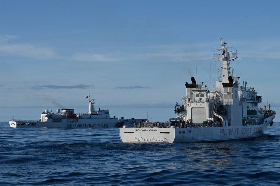 A China Coast Guard vessel (left) blocks BRP Melchora Aquino (right) during the Philippine Coast Guard's mission to deliver provisions at Second Thomas Shoal in the South China Sea on 10 November 2023. (Jam Sta Rosa/AFP)