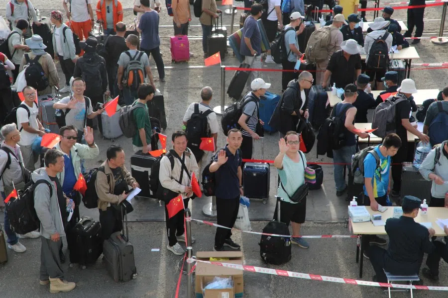 People line up for checks at Port Sudan as Chinese People's Liberation Army (PLA) Navy dispatched ships for an evacuation mission in Sudan, 26 April 2023. (cnsphoto via Reuters)