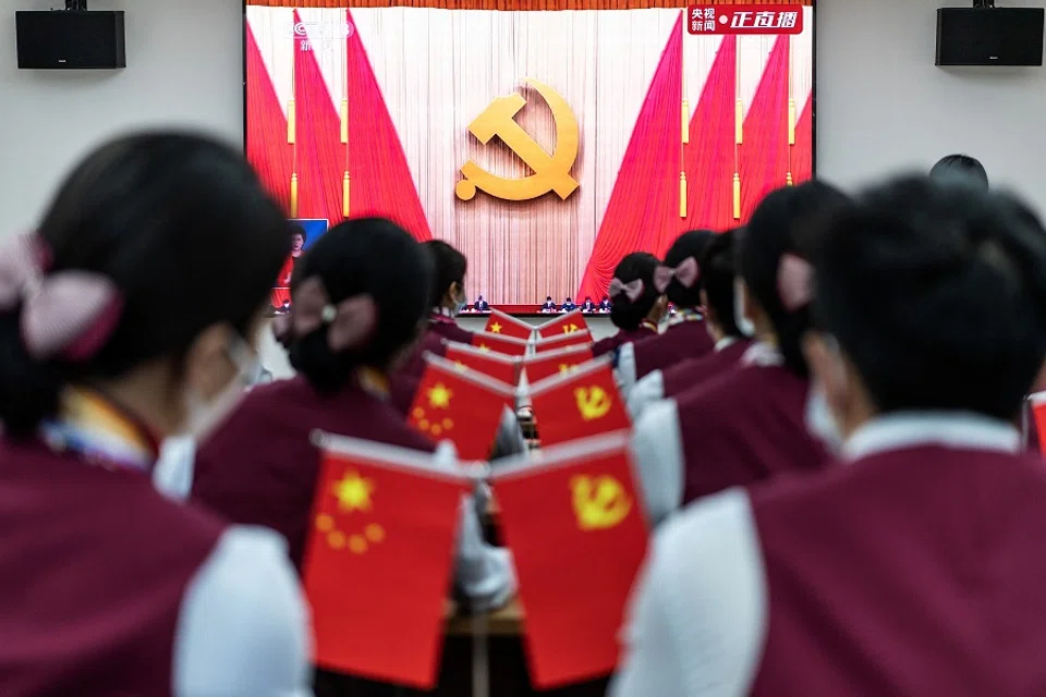 This photo taken on 16 October 2022 shows subway staff watching the opening session of the 20th Party Congress in Wuhan, Hubei province, China. (AFP)